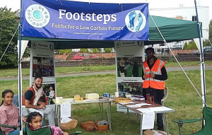 Under the Footsteps banner, a man in a hi-vis vest sits alongside two children.