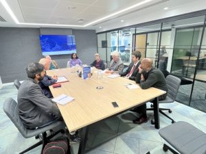 Footsteps members sat around a conference table with Lord Hunt.